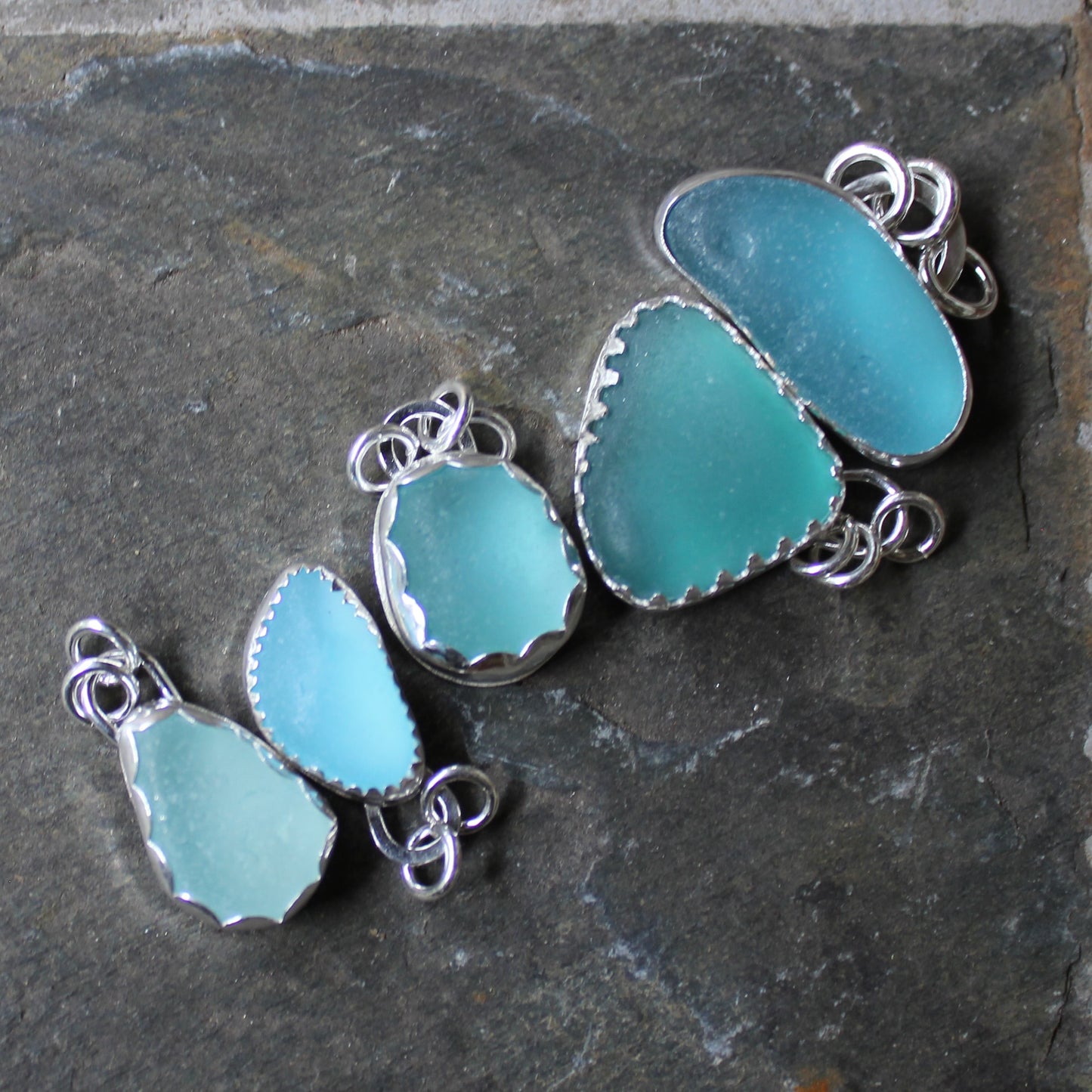 Five handmade aqua blue and turquoise sea glass pendants in sterling silver
