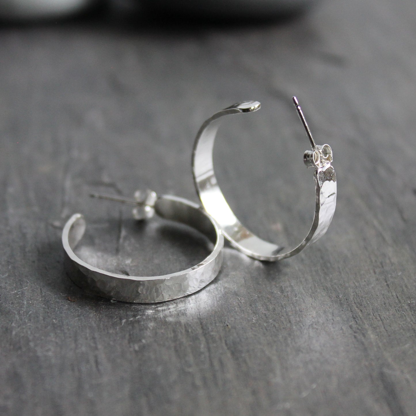 4mm wide hammered sterling silver hoop earrings on sterling silver posts that are about 1 inch in diameter. 