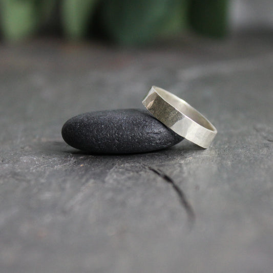 This is a plain hammered sterling silver ring that is approximately 4mm wide and 1mm thick.  