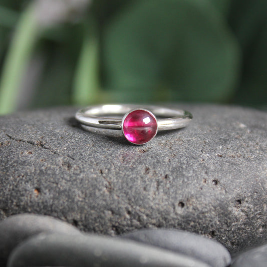A handmade sterling silver 6mm bezel set lab created ruby on a sturdy silver band. 