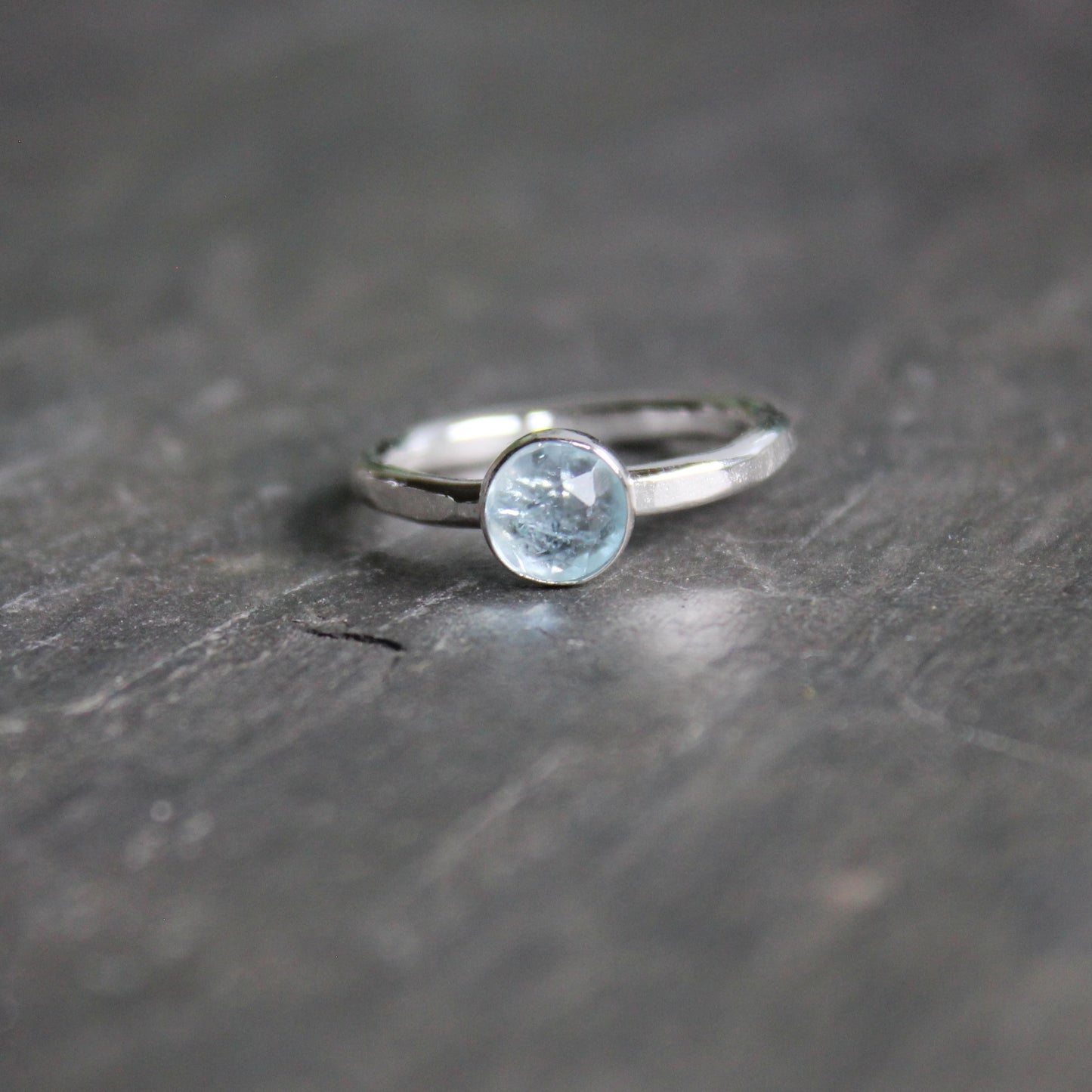 6mm rose cut aquamarine in a sterling silver bezel setting on a sturdy silver band. 
