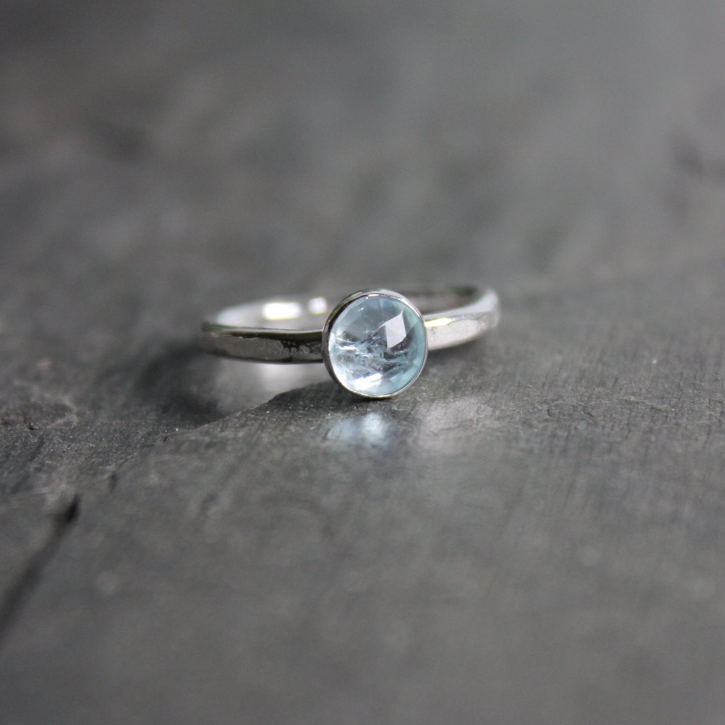 6mm rose cut aquamarine in a sterling silver bezel setting on a sturdy silver band. 