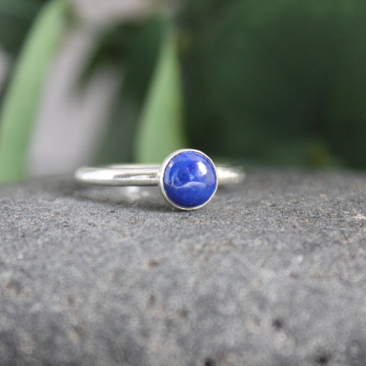 A 6mm round lapis lazuli cabochon set in a handmade sterling silver bezel setting on a sturdy silver band. 