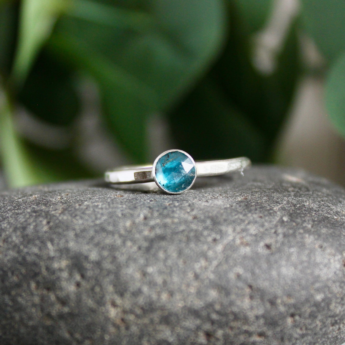 6mm rose cut teal moss kyanite set in a sterling silver bezel setting on a sturdy silver band. 
