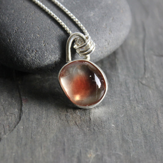 Handmade sterling silver red Oregon sunstone cabochon set in a fine and sterling silver bezel setting on a sterling silver chain.