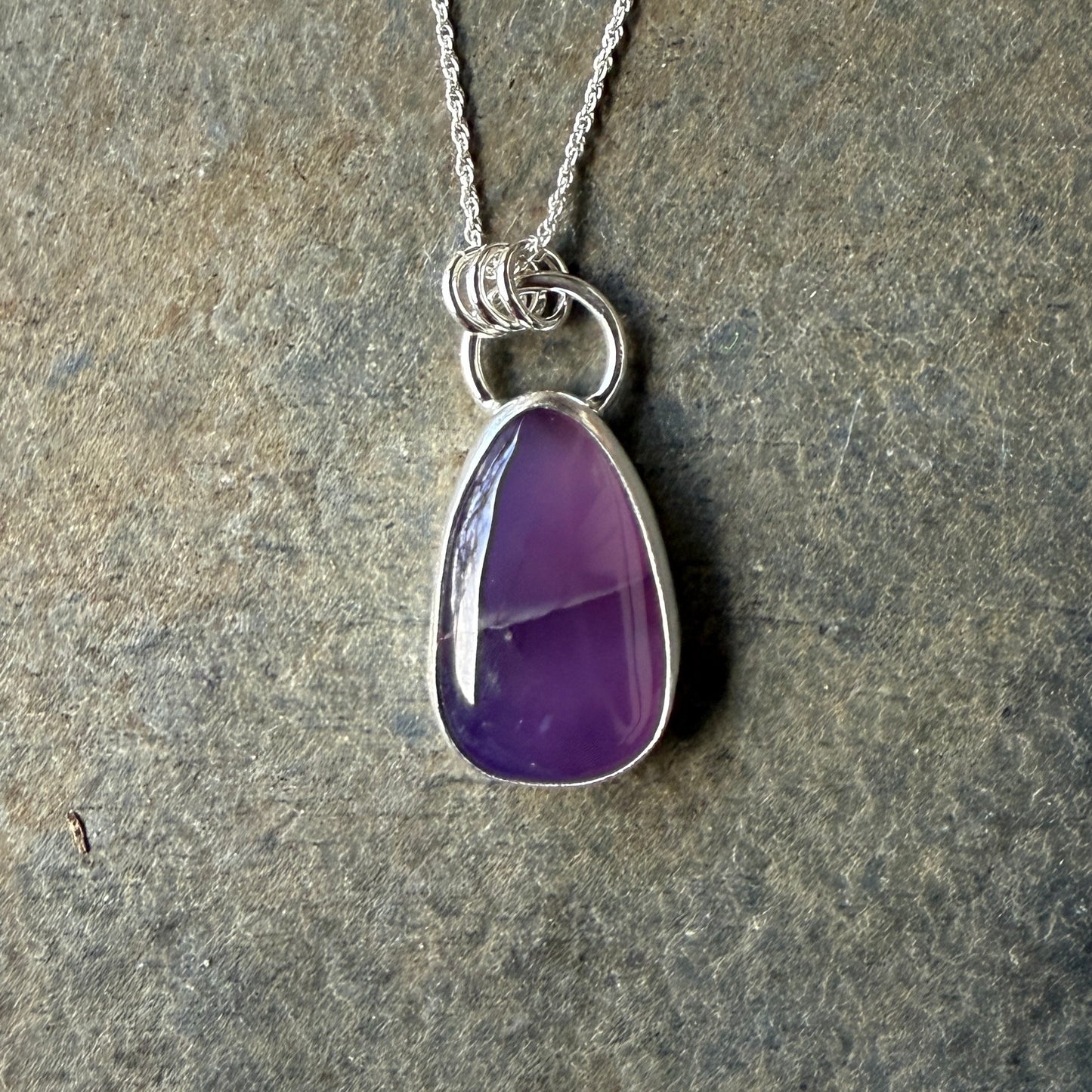 This pendant has a large Oregon Holley Blue agate cabochon that is set in a fine and sterling silver bezel setting and comes with a sterling silver chain. Handmade by Will Macy in Corvallis, OR.
