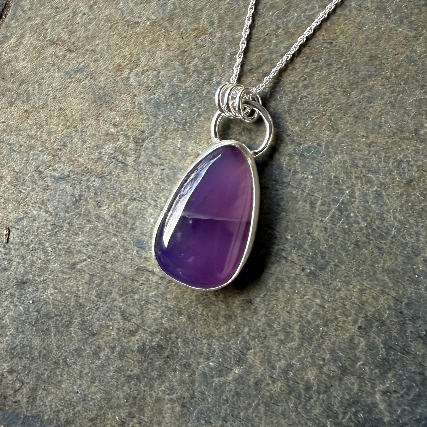 This pendant has a large Oregon Holley Blue agate cabochon that is set in a fine and sterling silver bezel setting and comes with a sterling silver chain. Handmade by Will Macy in Corvallis, OR.
