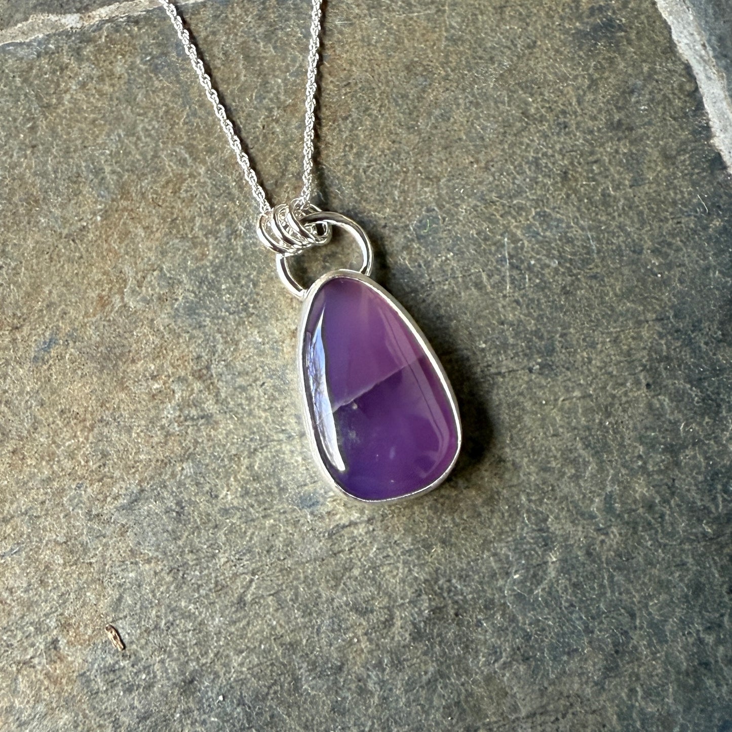 This pendant has a large Oregon Holley Blue agate cabochon that is set in a fine and sterling silver bezel setting and comes with a sterling silver chain. Handmade by Will Macy in Corvallis, OR.