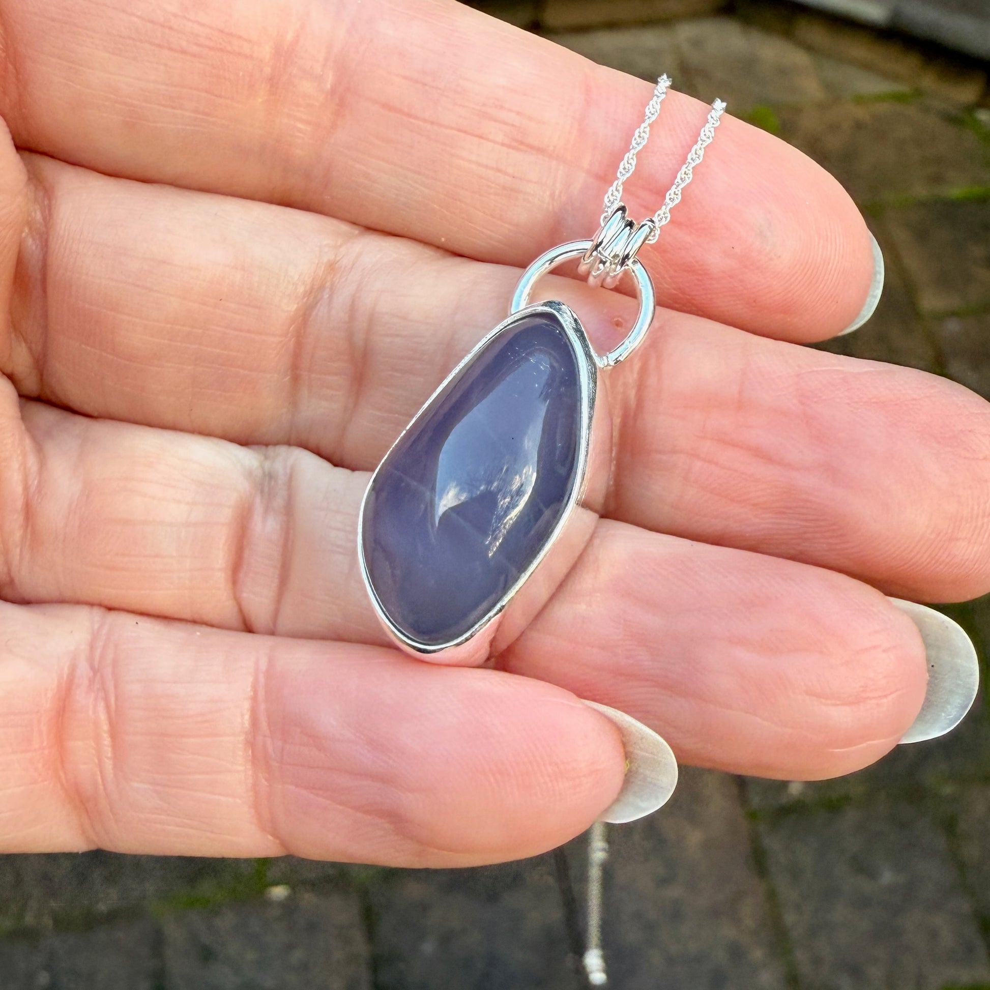 This is a genuine Oregon Holley Blue agate cabochon that is set in fine & sterling silver and comes with a sterling silver chain. Holly Blue agate is a rare gemstone that is found only in a small area of private timberland near Sweethome, OR.
