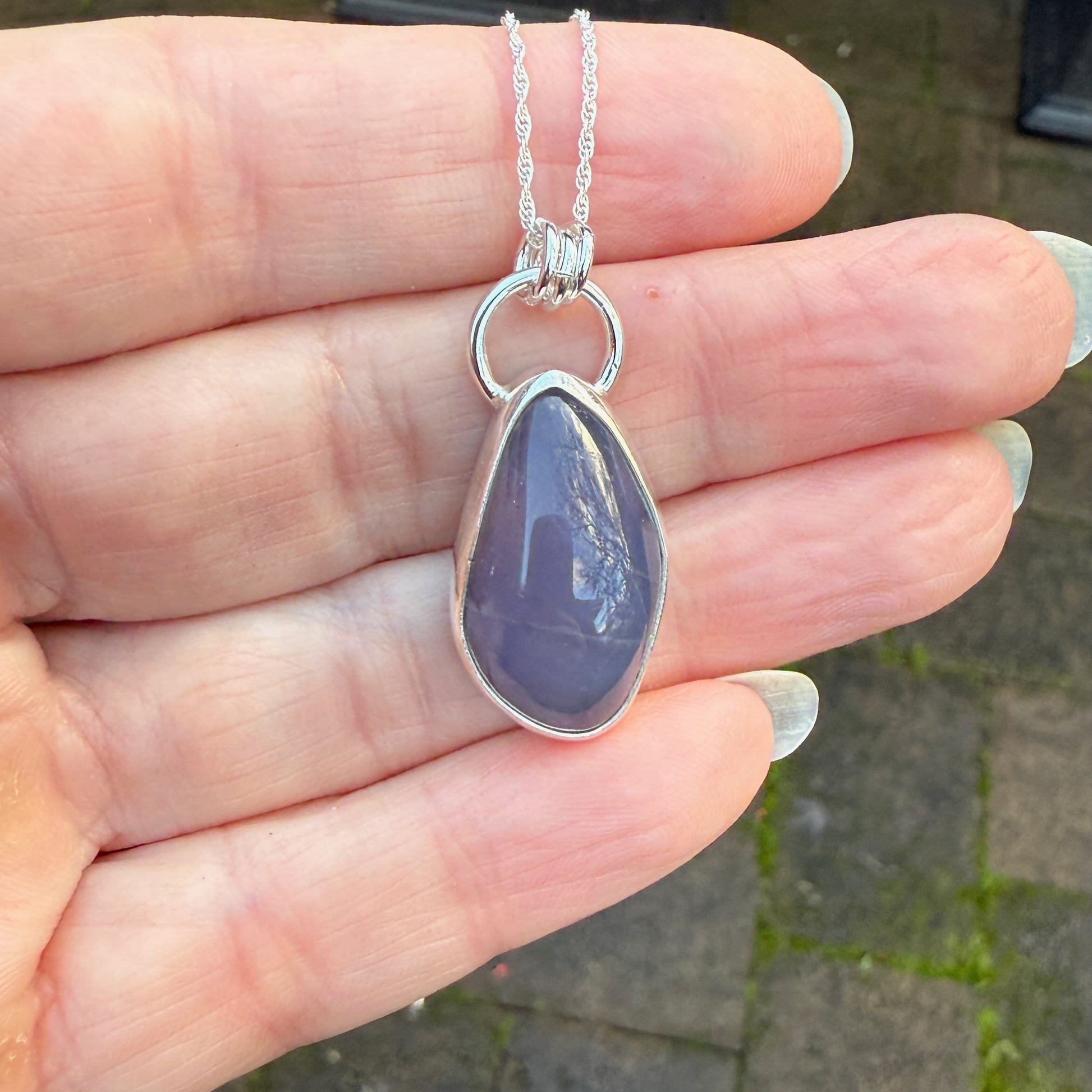 This is a genuine Oregon Holley Blue agate cabochon that is set in fine & sterling silver and comes with a sterling silver chain. Holly Blue agate is a rare gemstone that is found only in a small area of private timberland near Sweethome, OR.