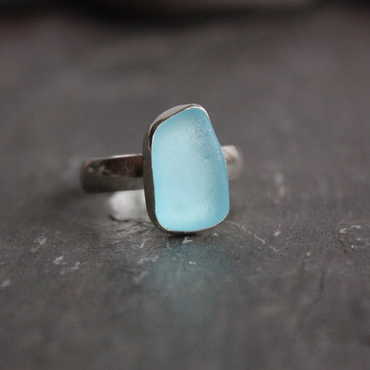 Aqua blue sea glass that is rectangular shaped and set in fine & sterling silver. Size 10. Accent Yourself specializes in sterling silver jewelry handmade by Barb Macy & Will Macy in Corvallis, OR. 