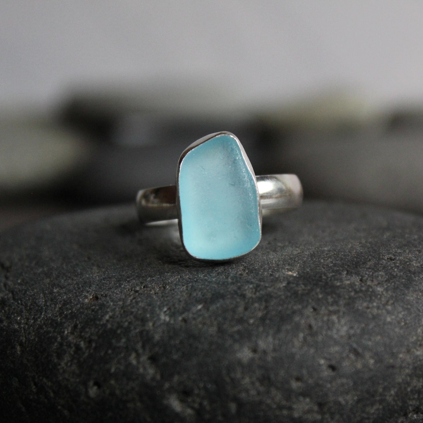 Aqua blue sea glass that is rectangular shaped and set in fine & sterling silver. Size 10. Accent Yourself specializes in sterling silver jewelry handmade by Barb Macy & Will Macy in Corvallis, OR.
