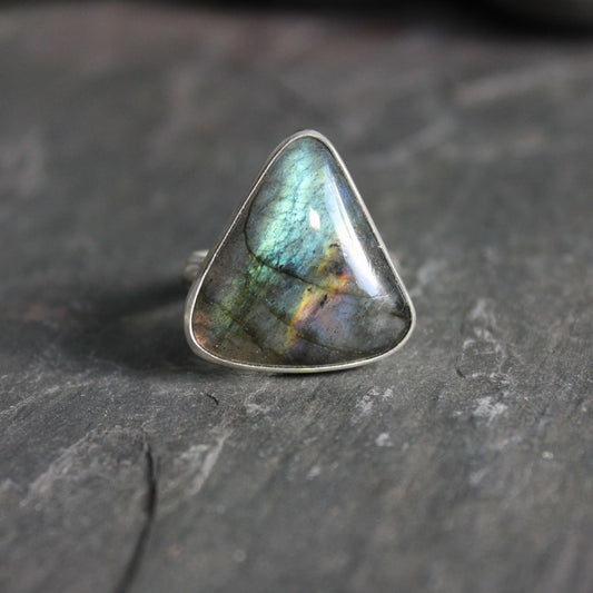 This is a very large triangular rainbow labradorite set in a fine & sterling silver bezel setting on a sturdy silver band. 