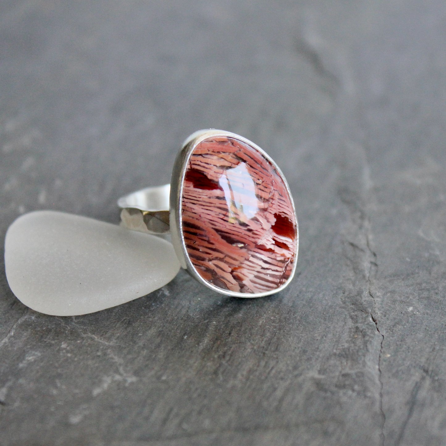 This large ring has a freeform rattlesnake jasper or Howardite cabochon that is set in a fine and sterling silver bezel setting on a sturdy hammered band. Size 11 3/4 Handmade by Will Macy in Corvallis, Oregon.