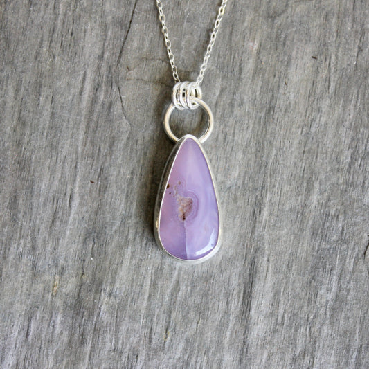 This pendant has a rare holley blue agate cabochon that is set in a fine and sterling silver bezel setting on a sturdy silver chain. Handmade by Will Macy in Corvallis, Oregon.