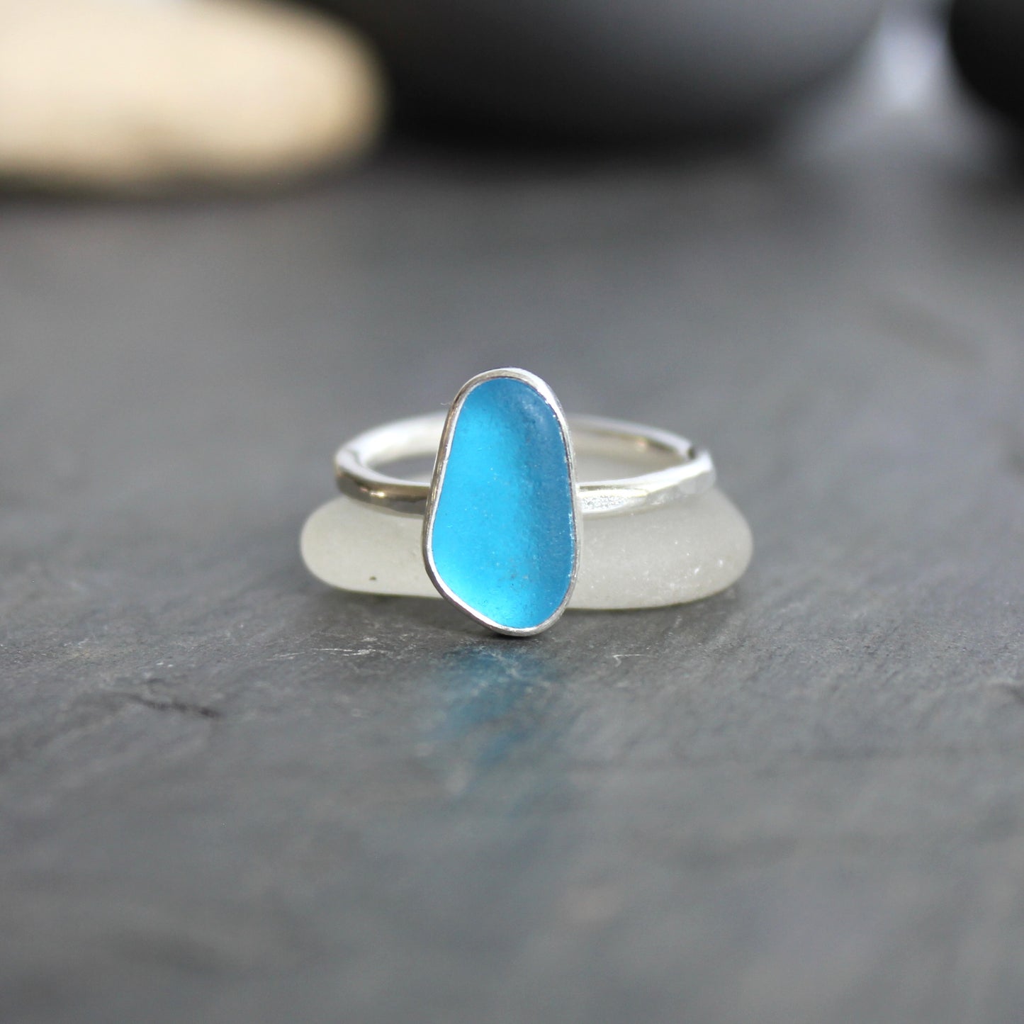 This ring has a piece of electric turquoise blue sea glass that is set in a fine and sterling silver bezel setting on a sturdy silver band. Size 7 3/4 Handmade by Barb Macy in Corvallis, OR.