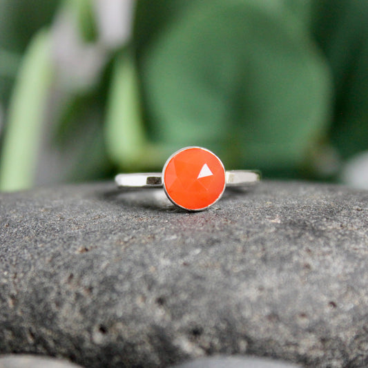 This is a small round rose cut (faceted) carnelian cabochon set in a sterling silver bezel setting on a narrow silver band.  Available in 6mm or 8mm diameter. 