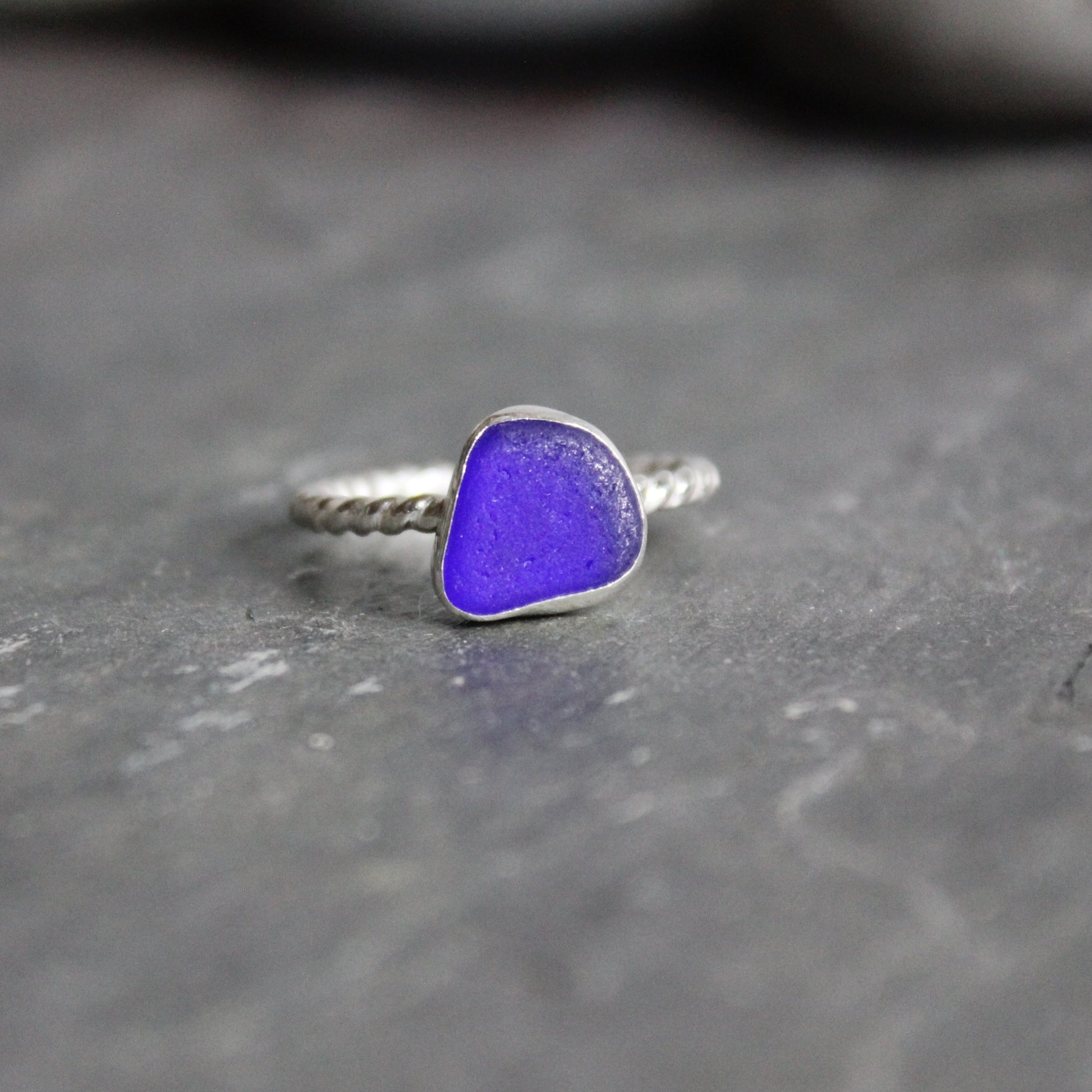 This ring has a cobalt blue stackable sea glass ring with a fine and sterling silver bezel setting on a twisted ring shank. Size 7 3/4 Handmade by Barb Macy of Accent Yourself in Corvallis, OR. 