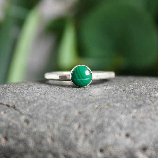 6mm round malachite cabochon set in a sterling silver bezel on a sturdy silver band. 
