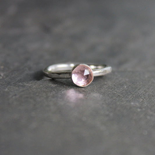A 6mm round rose cut bezel set morganite gemstone on a sturdy handmade sterling silver band.