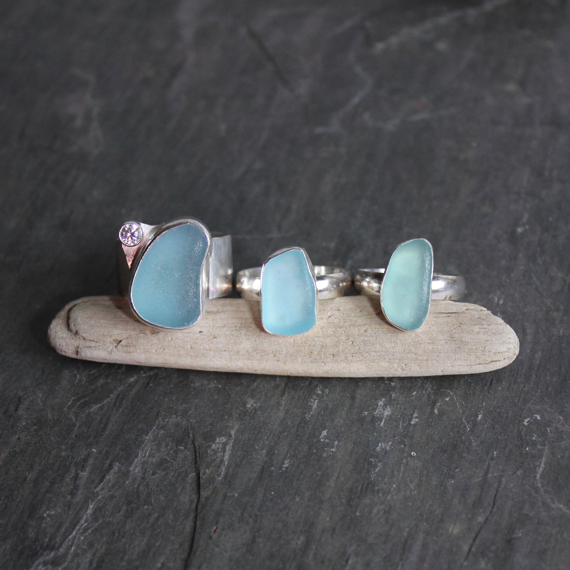 Three handmade sterling silver aqua blue sea glass statement rings made by Barb Macy in Corvallis, OR. 