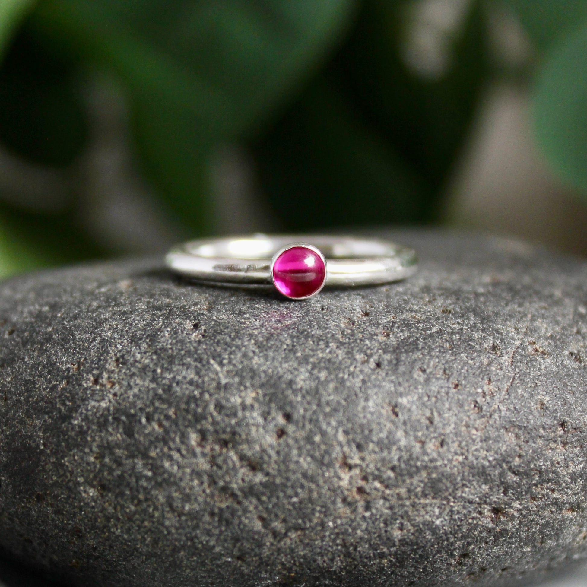 A handmade sterling silver 4mm bezel set lab created ruby on a sturdy silver band. 