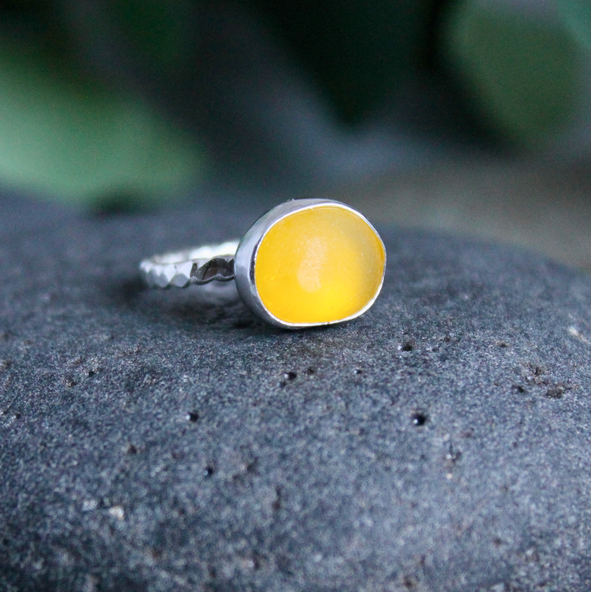 This is a rare piece of golden yellow sea glass set in a fine and sterling silver bezel setting on a twisted wire band.  Size 5 3/4