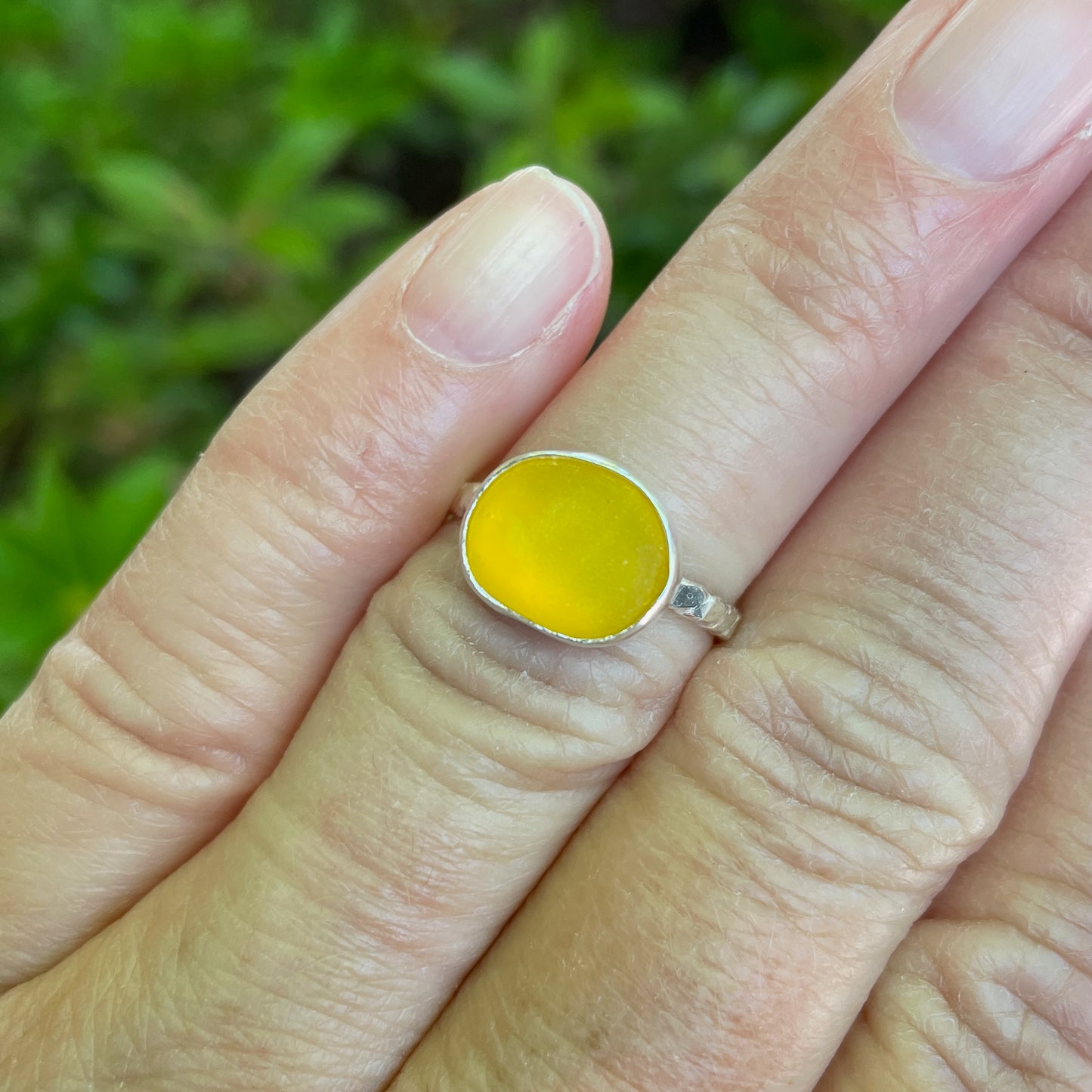 This is a rare piece of golden yellow sea glass set in a fine and sterling silver bezel setting on a twisted wire band.  Size 5 3/4 modeled on hand