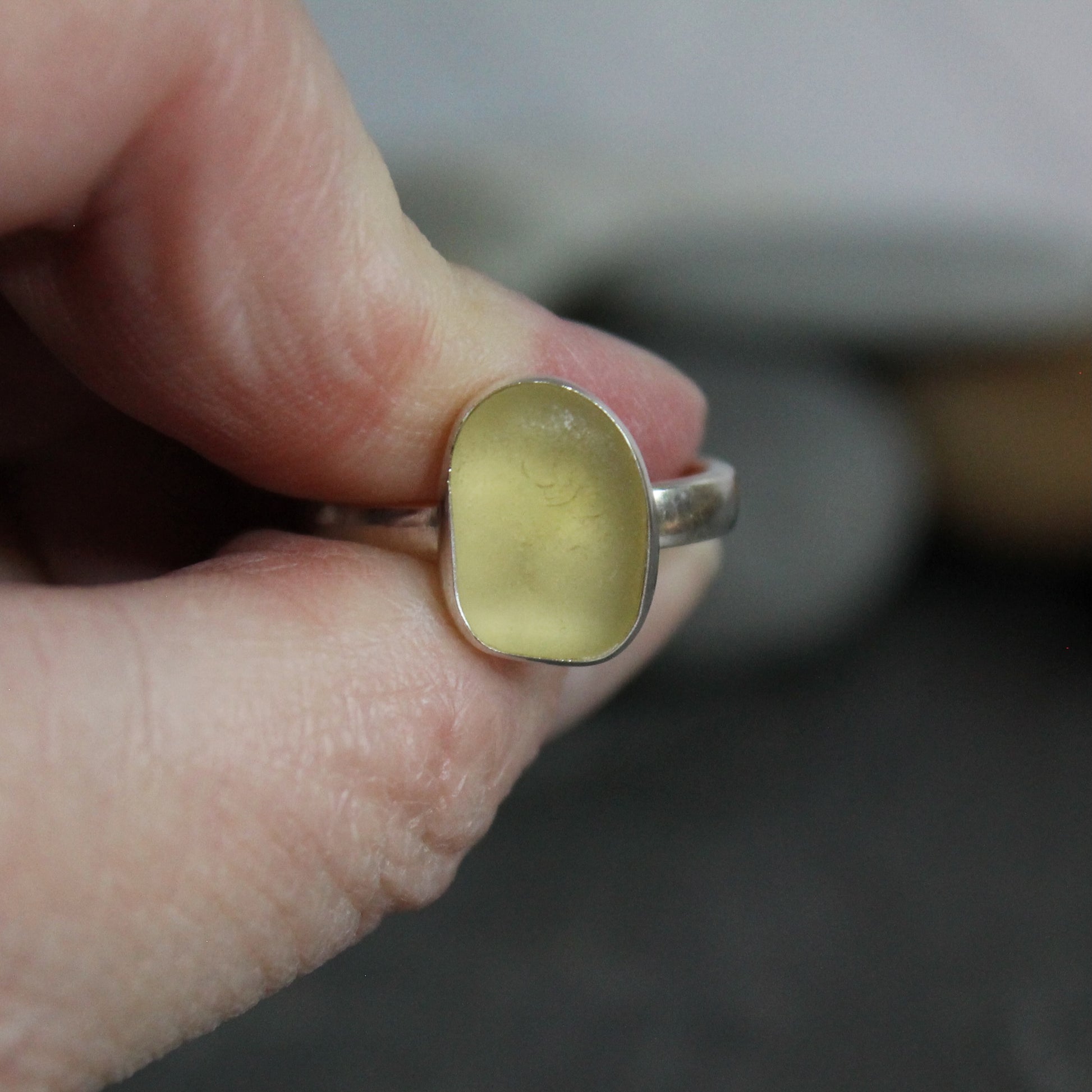 This ring has a pale yellow piece of sea glass set in a fine & sterling silver bezel setting on a sturdy silver band. 