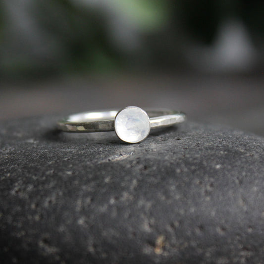 6mm round rainbow moonstone cabochon set in a sterling silver bezel on a sturdy silver band. 