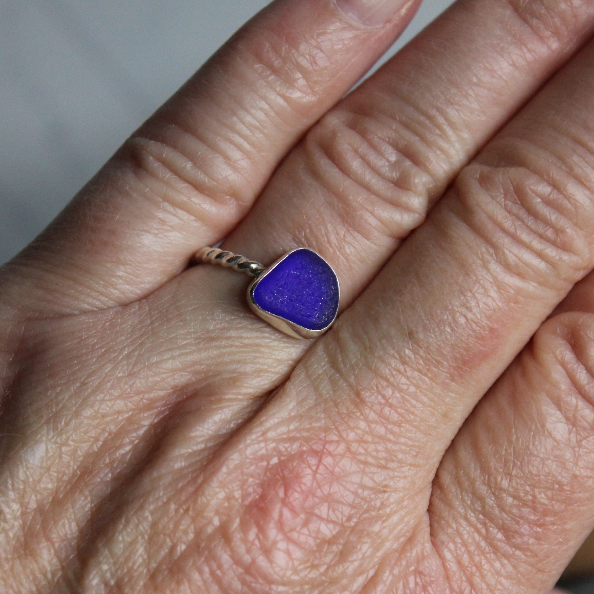 This ring has a cobalt blue stackable sea glass ring with a fine and sterling silver bezel setting on a twisted ring shank. Size 7 3/4 Handmade by Barb Macy of Accent Yourself in Corvallis, OR. 