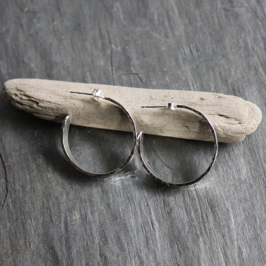 4mm wide hammered sterling silver hoop earrings on sterling silver posts that are about 1 inch in diameter. 