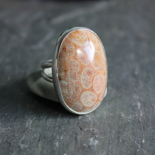 This is a huge fossilized coral cabochon set in a fine and sterling silver bezel setting with a split band.  Size 8