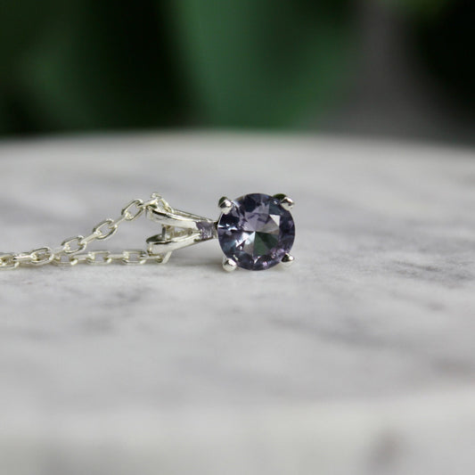 This necklace has a 6mm round faceted simulated alexandrite set in a 4-prong sterling silver pendant setting on a sterling silver chain.