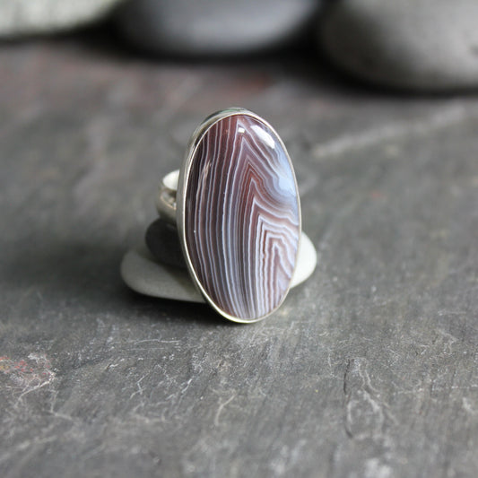 This ring has a huge oval brown Botswana agate set in a fine and sterling silver bezel setting on a sturdy silver band.  Size 9 1/4