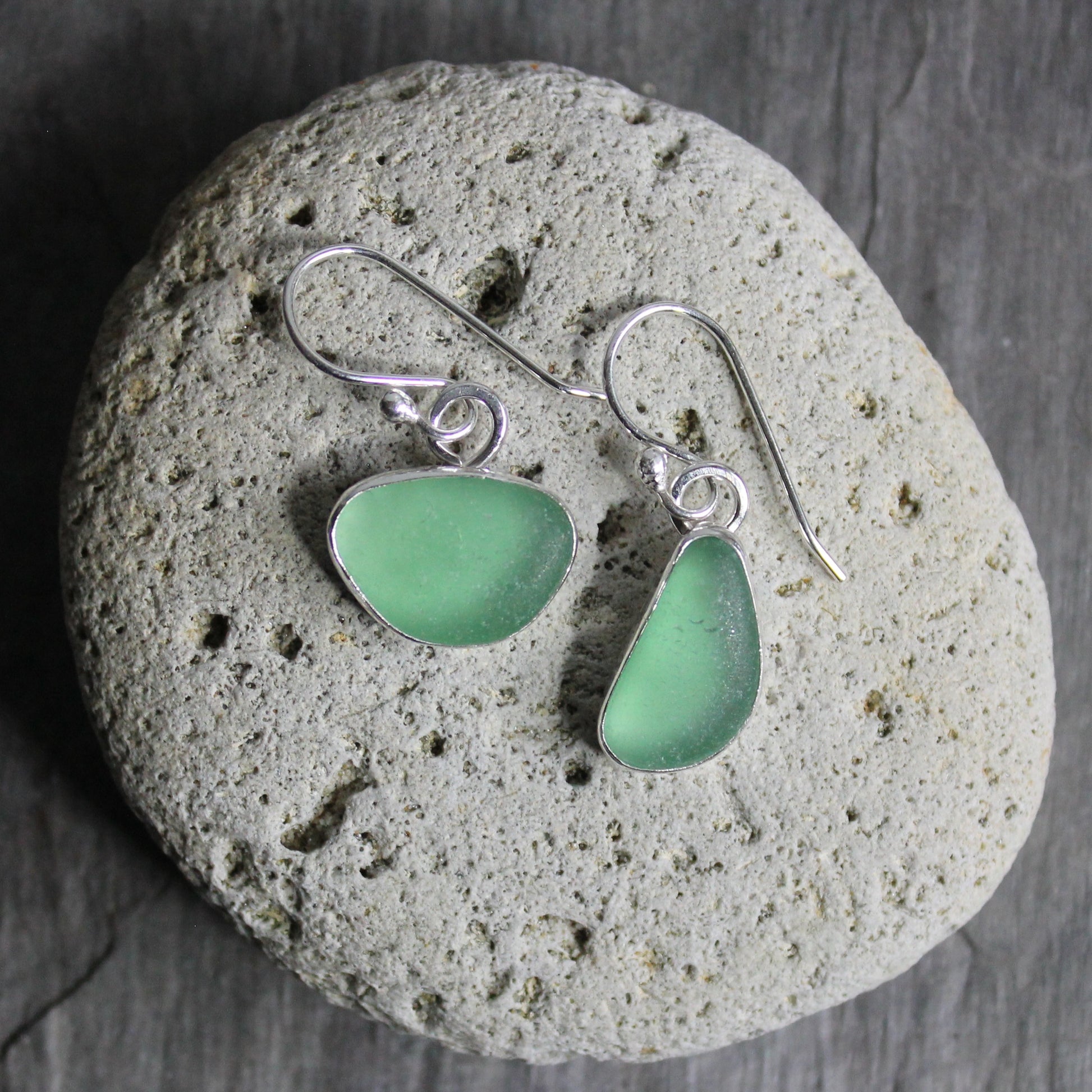 These mismatched dangly sage green earrings are set in a fine & sterling silver bezel setting on handmade ear wires. 
