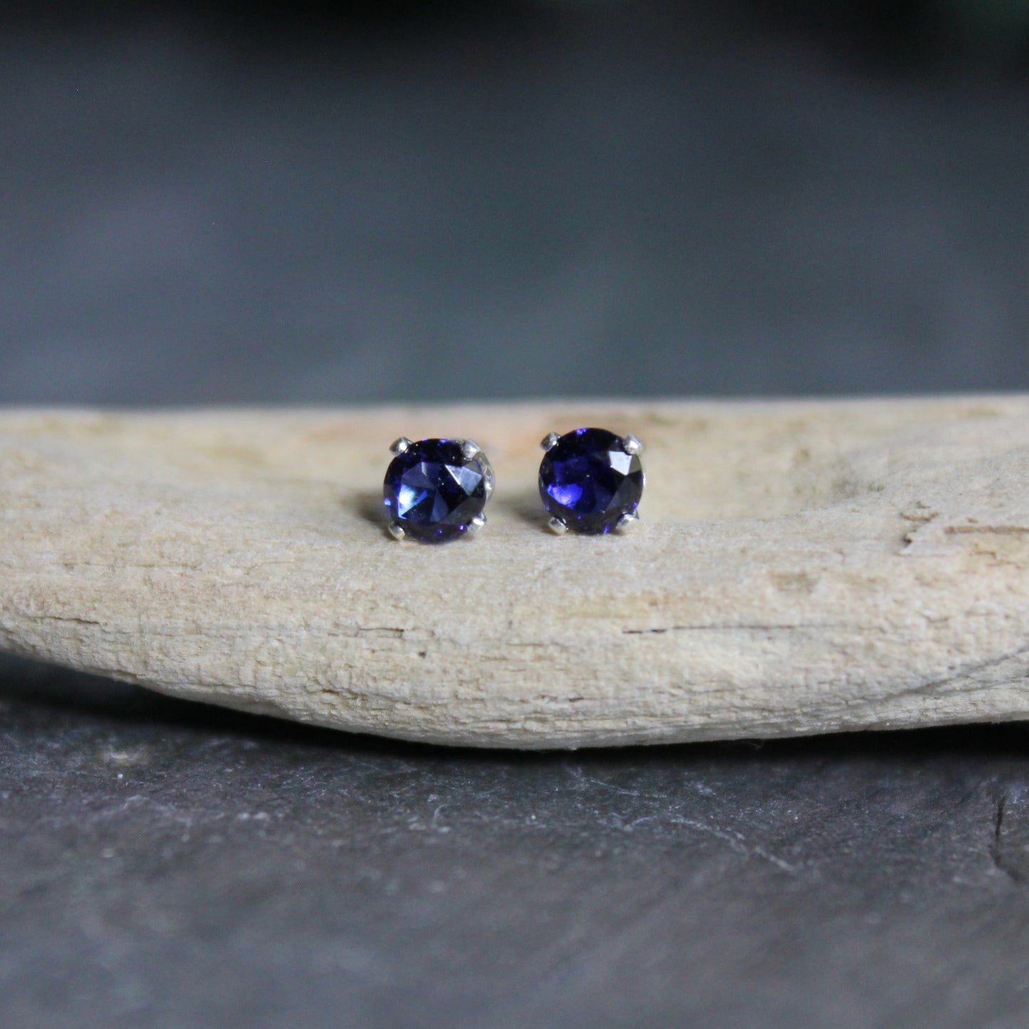 These stud earrings are made with 4mm round faceted lab created sapphires set in 4-prong sterling silver stud earrings with earring backs.