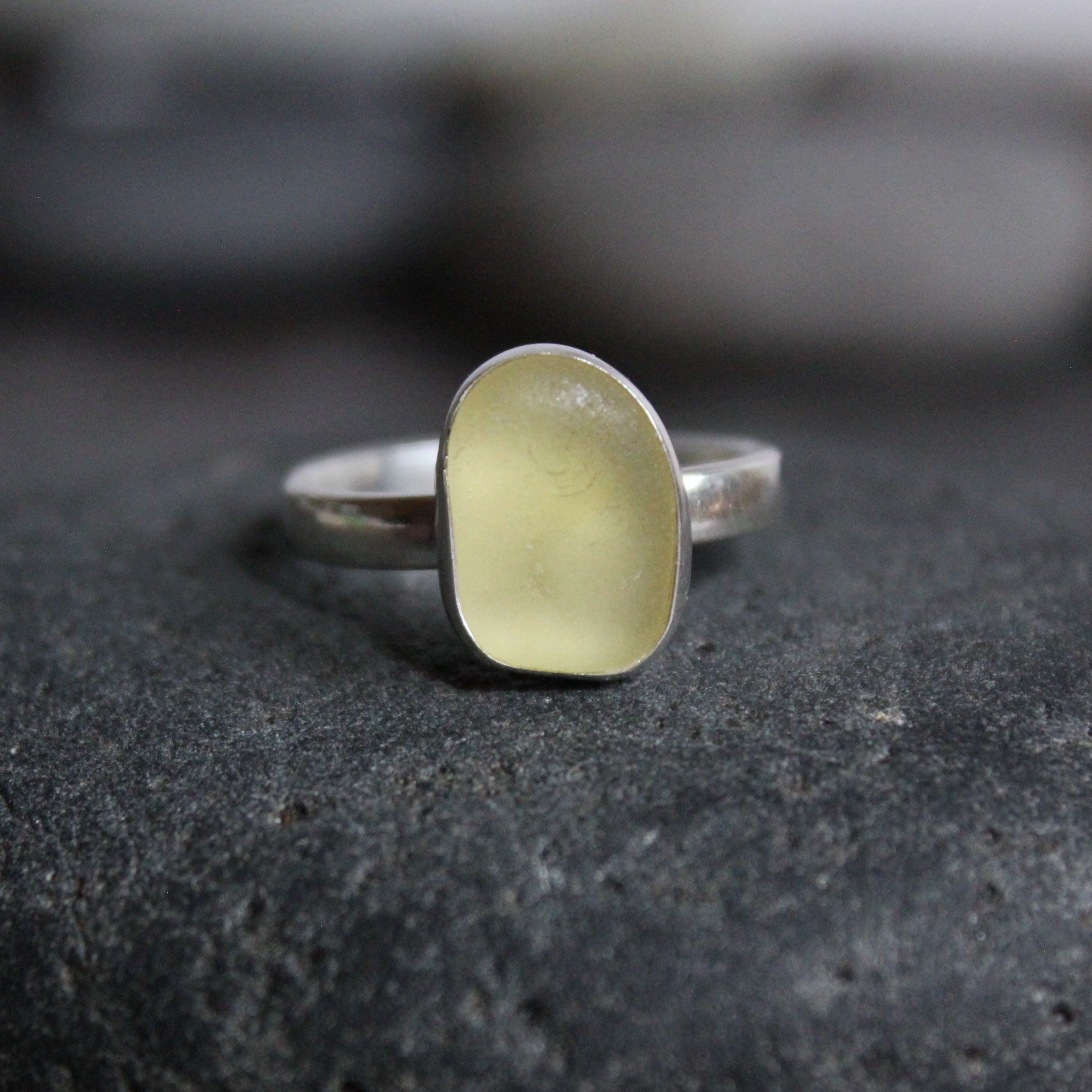 This ring has a pale yellow piece of sea glass set in a fine & sterling silver bezel setting on a sturdy silver band. 