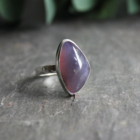 This ring has an approximately 22mm x 13mm dark Holley blue agate set in a fine and sterling silver bezel setting on a sturdy hammered band.  Size 10 3/4