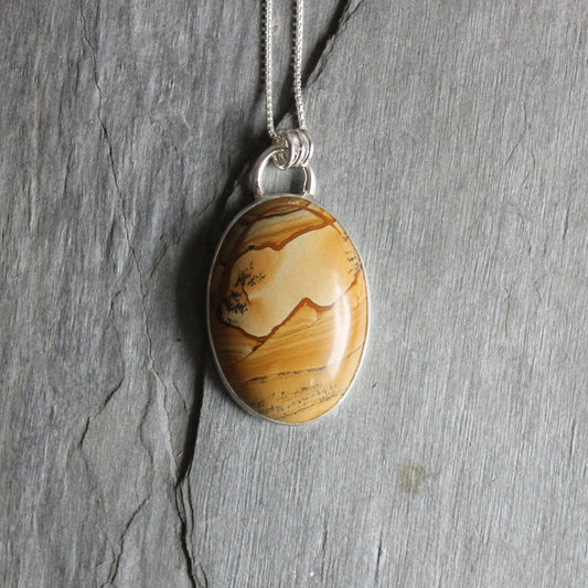 This is a very large Owyhyee picture jasper pendant set in a fine and sterling silver bezel setting.  