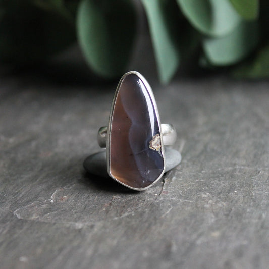 This is a dark Holley blue agate set in a fine and sterling silver bezel setting with a sturdy silver band.  Size 8 3/4