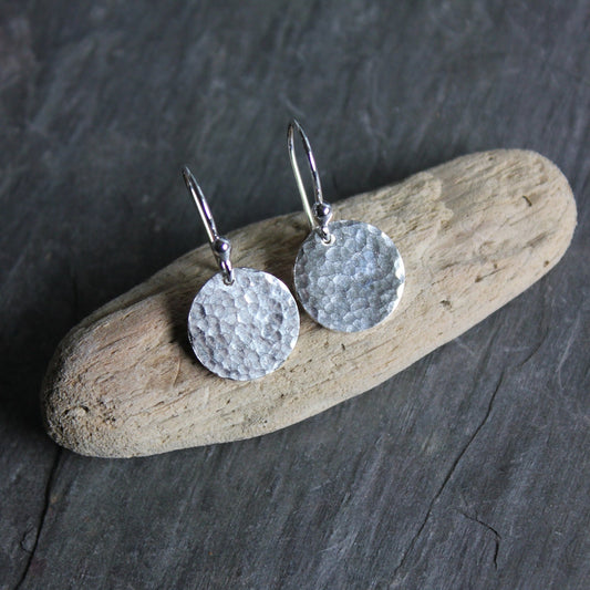 1/2 inch solid sterling silver discs with a hammered finish on both sides, attached to handmade ear wires.