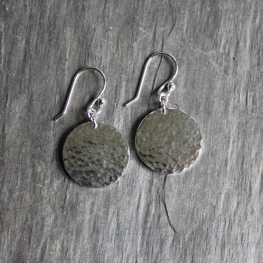 Sterling silver 3/4" discs with a bright finish and hammered for texture...attached to sterling silver ear wires. 