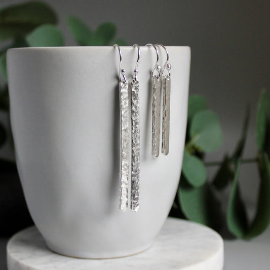 Hammered silver bar earrings made with 3mm x 1mm sterling silver wire that is hammered with a bright finish.  Length is 1.25" & 2" from handmade ear wires. 