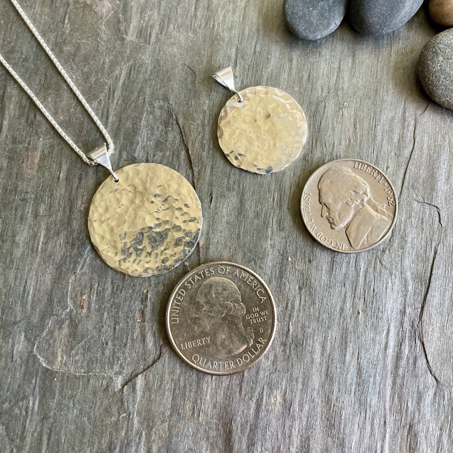 This necklace has an approximately 1 inch hammered sterling silver disc that comes on a sterling silver chain.  Size comparable to a quarter. 
