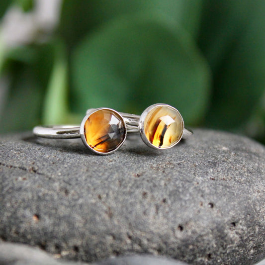 This is two 7-8mm round Montana agate cabochons set in a sterling silver bezel on a narrow hammered band. Each ring is sold separately. 