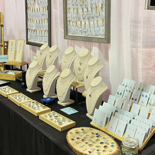 Handmade jewelry booth display at an outdoor art market — Accent Yourself sea glass and gemstone jewelry
