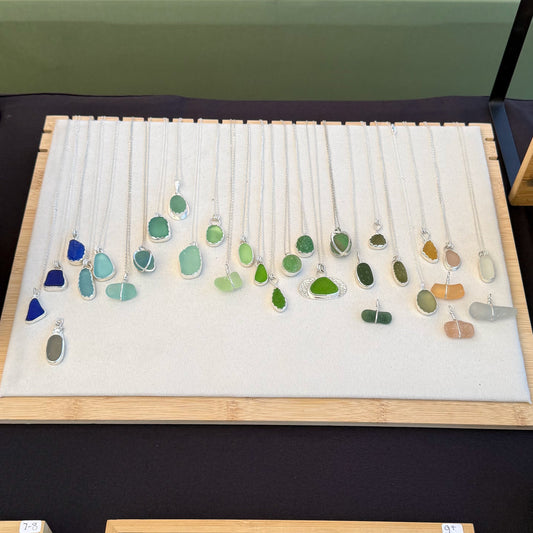Flat-lay jewelry display at the Yachats Farmers Market on the Oregon Coast