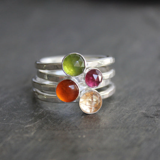 A sterling silver gemstone stacking ring set with serpentine, rhodolite garnet, amber, and citrine
