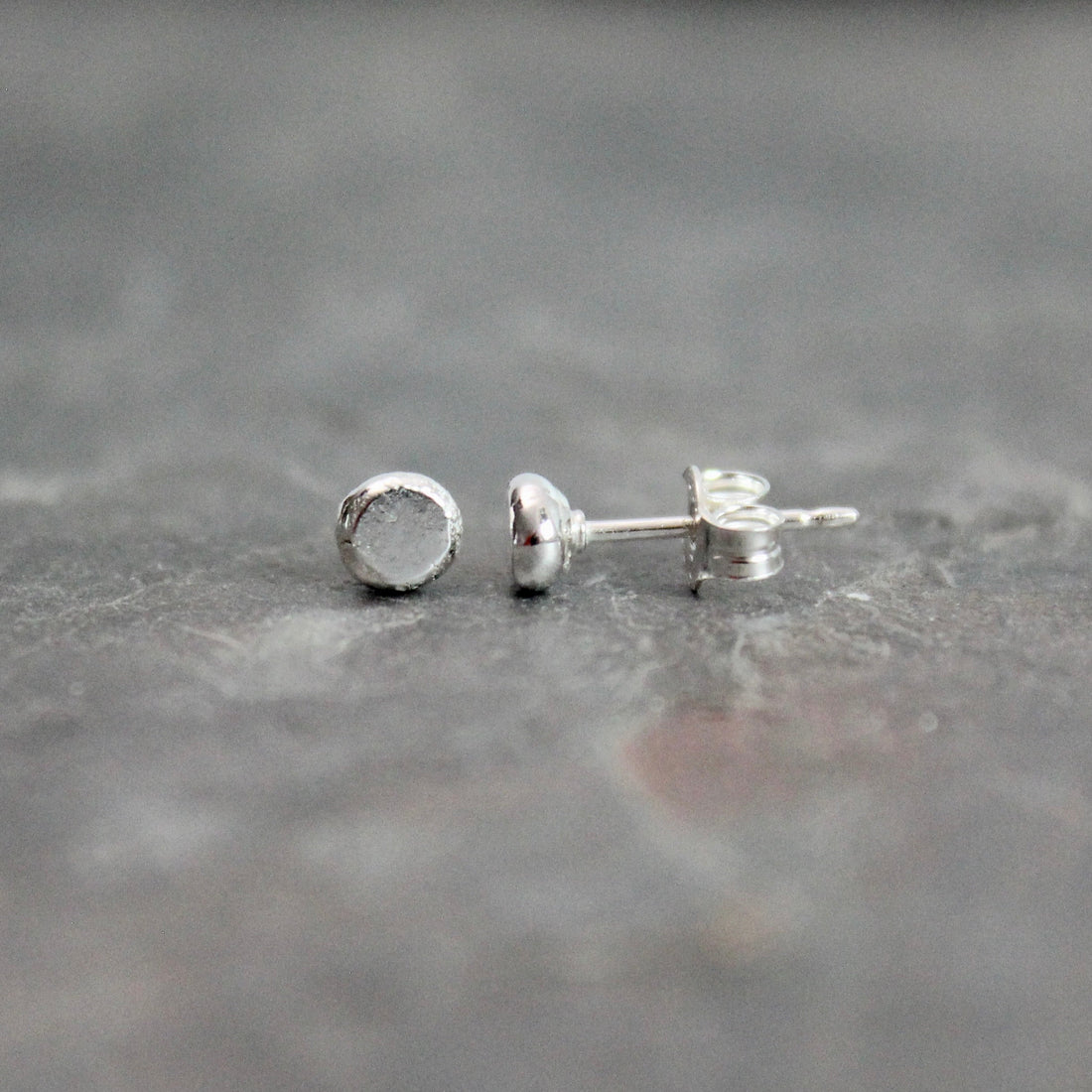 Recycled sterling silver tiny dot stud earrings — a best-selling handmade jewelry item at craft fairs and markets